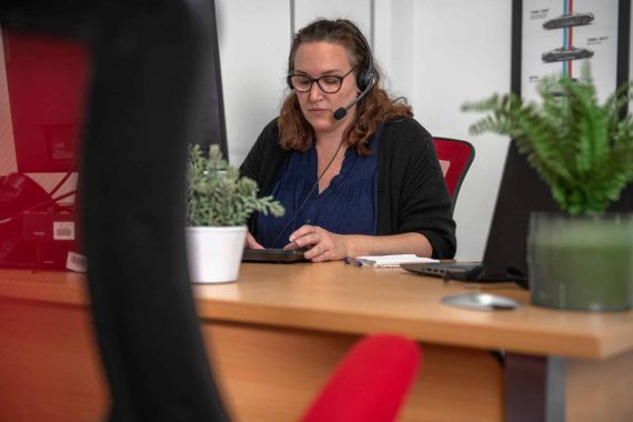 A call centre employee working at her computer