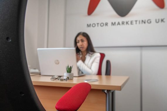 Shevani taking a call whilst looking at data on her laptop